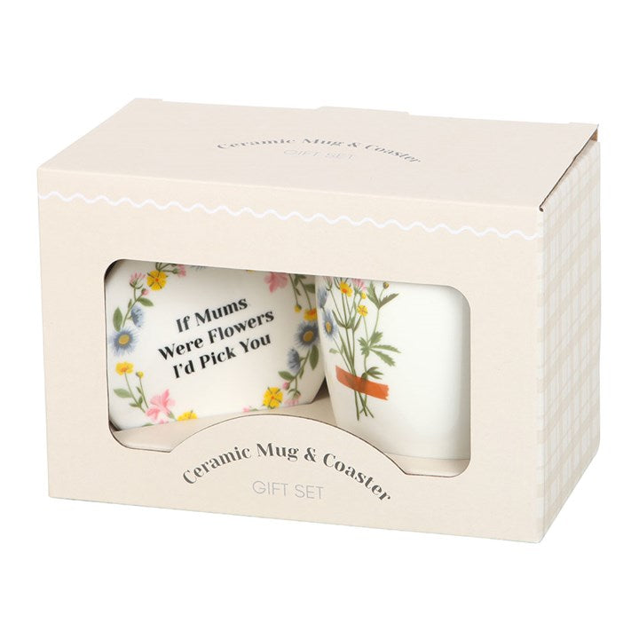 Ceramic mug and coaster set in a box with floral designs and text.
