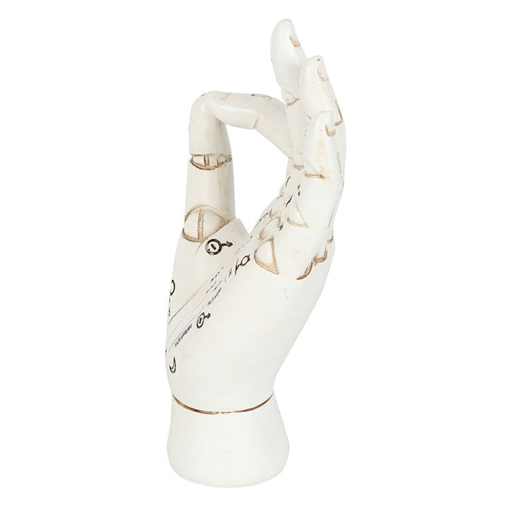 White ceramic hand with gold accents on a white background