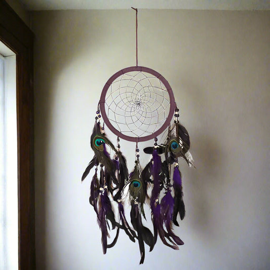 Dreamcatcher with feathers and beads on a white background